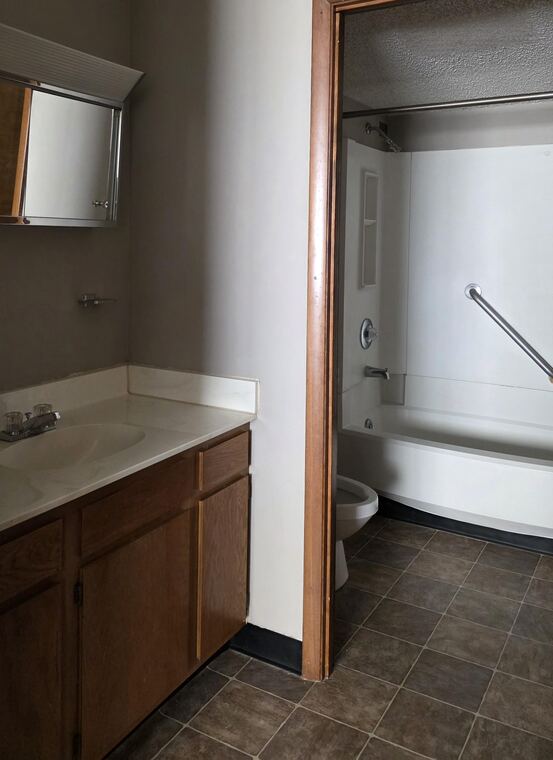 Bathroom with vanity and tub
